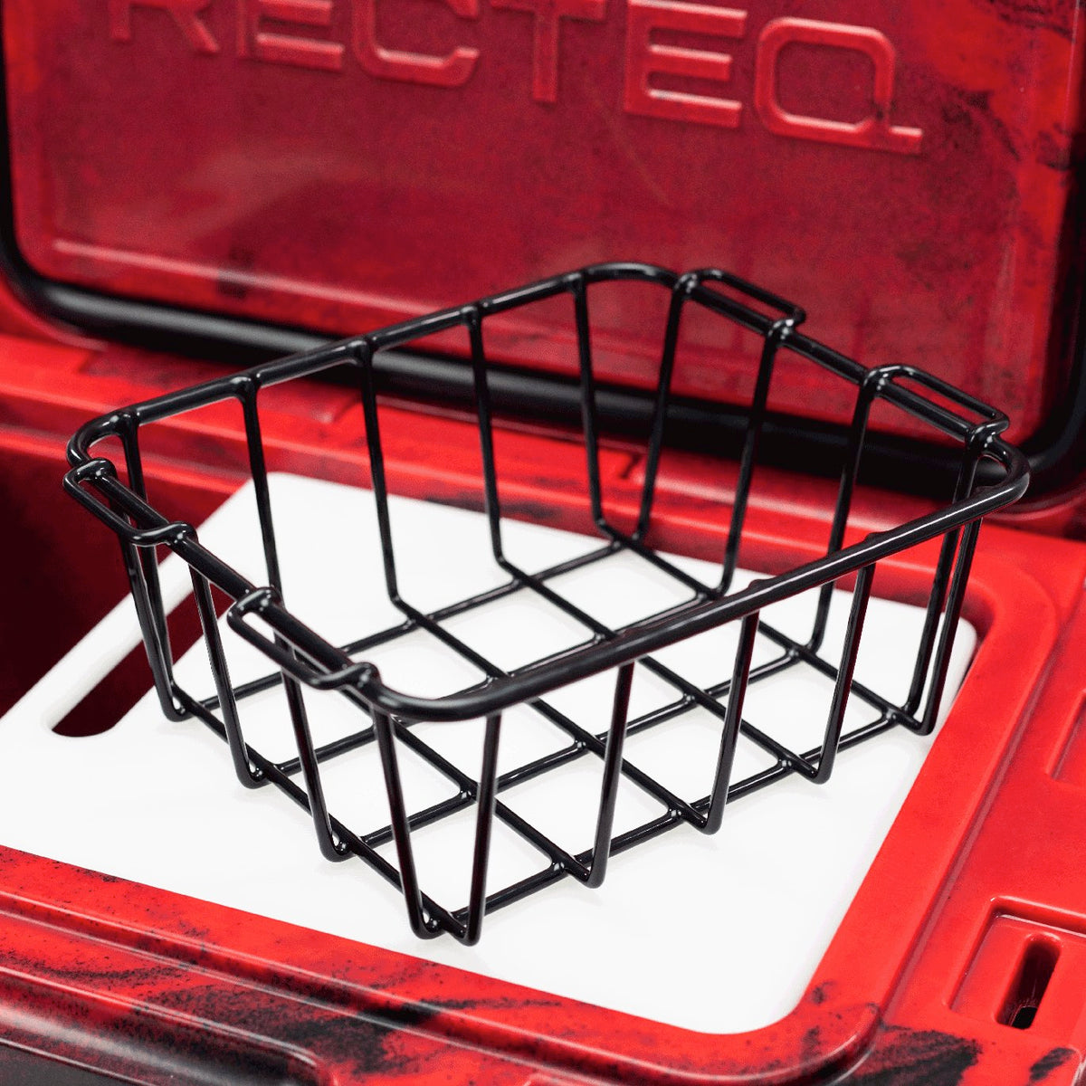 Zoomed inside of 20 quart Red and Black ICER cooler with integrated cutting board/divider and storage basket.