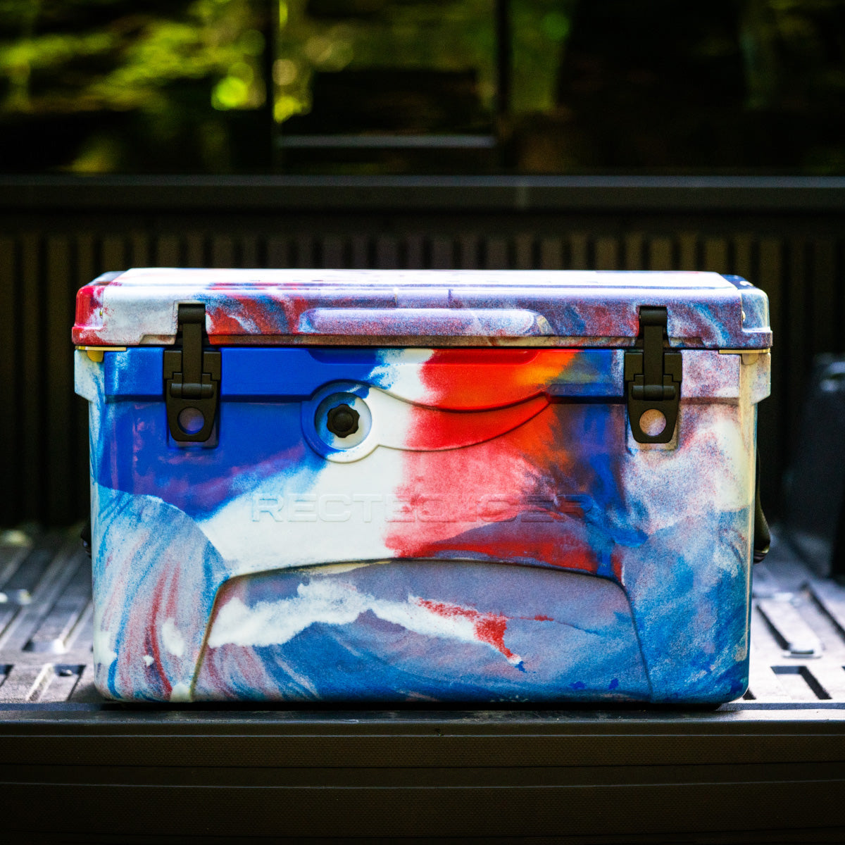 45qt. Red, White and Blue RECTEQ ICER cooler closed and on a truck tailgate.